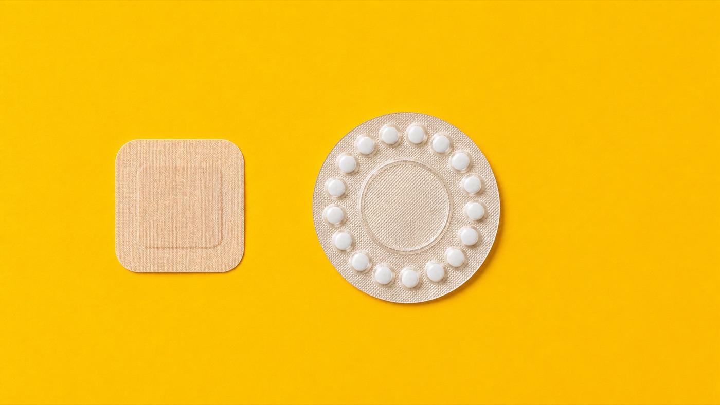 A skin patch beside a round blister pack of pills on a bright yellow background